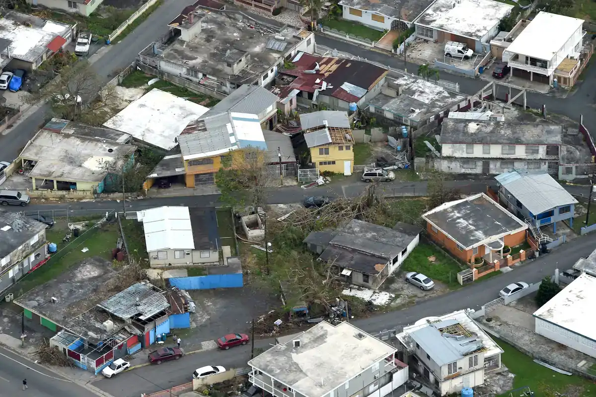 Aerial view of homes and businesses with roofs stripped and damaged by Hurricane Maria in Puerto Rico