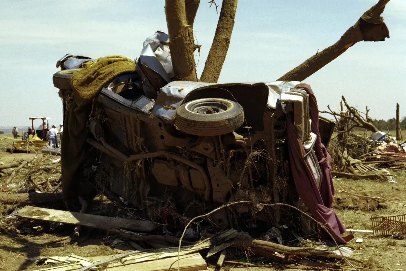 Car wrapped around a tree trunk by the winds of a tornado near Binger, Oklahoma