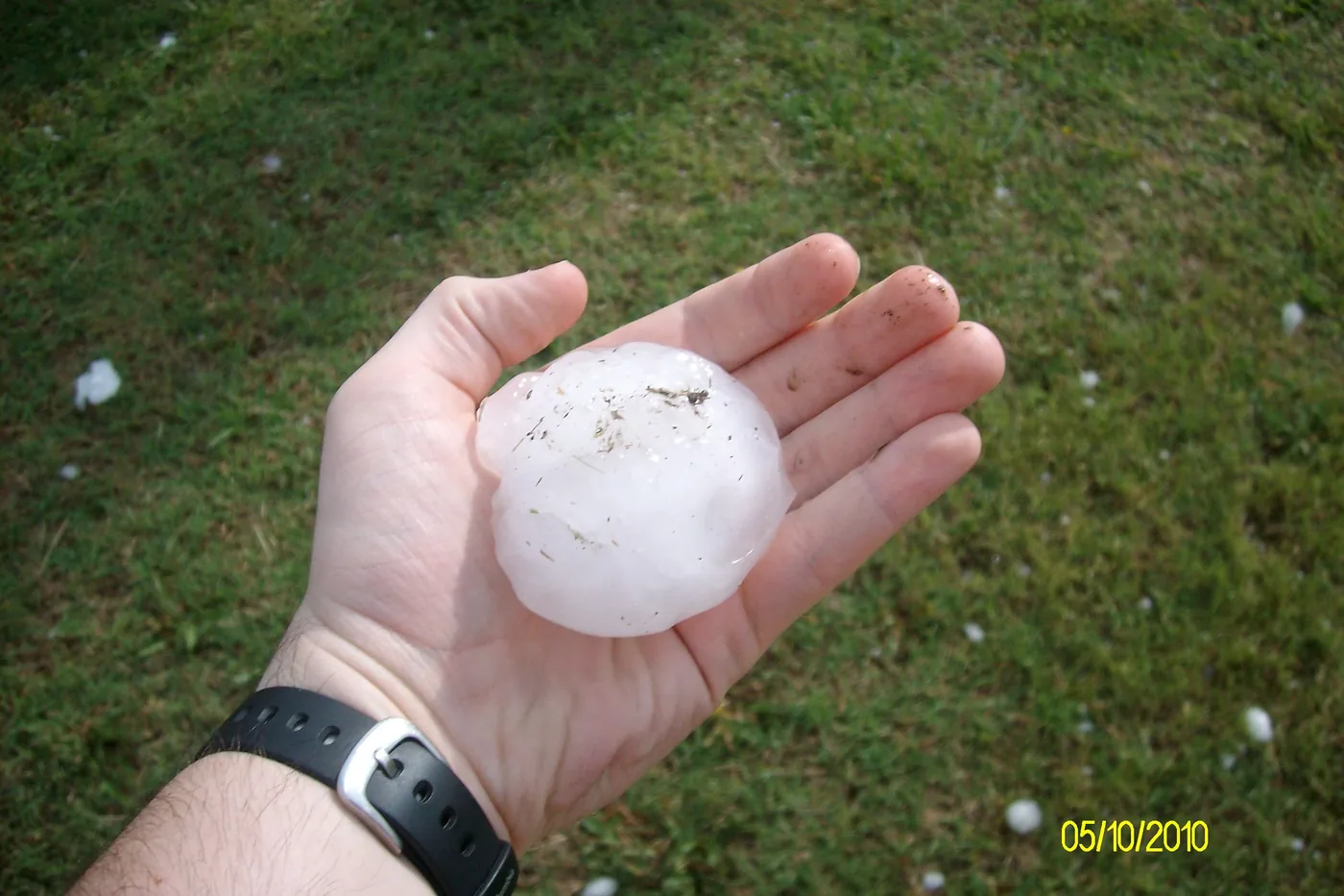 Large hailstone resting in an open palm, photographed in Billings, Oklahoma