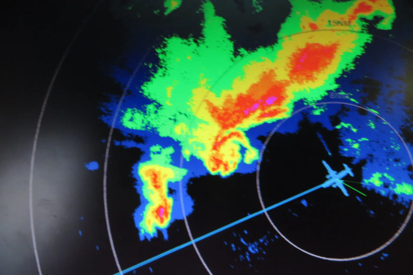 Airborne radar display aboard a NOAA aircraft showing a hook-shaped echo wrapped into a mesocyclone over western Nebraska