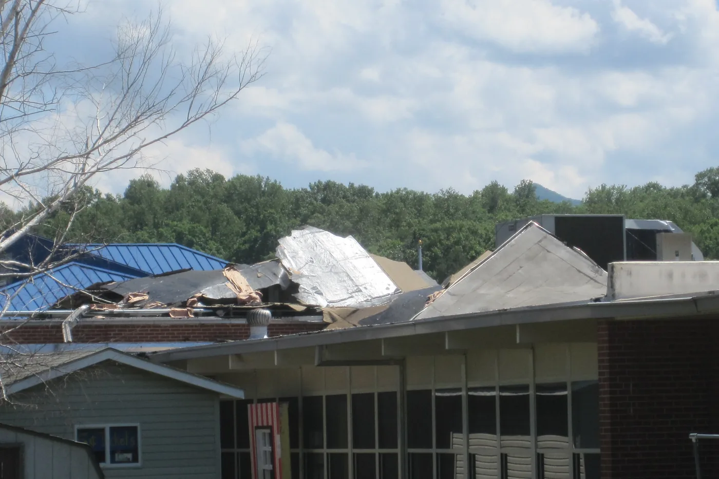 School building roof peeled up and folded over by high winds in Sylva, North Carolina