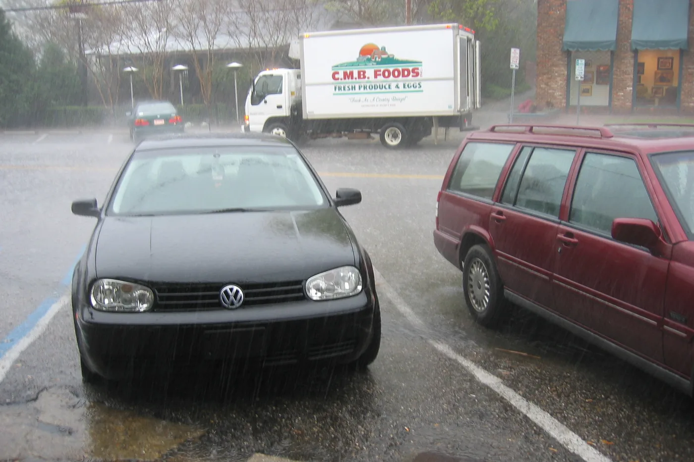 Heavy rain from a thunderstorm pouring onto a street and parked cars in Montgomery, Alabama