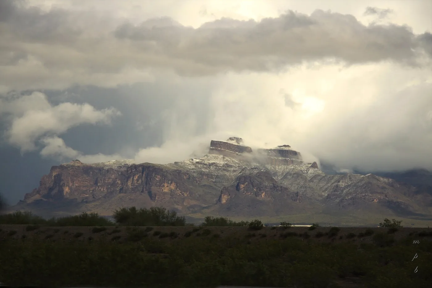 Storm clouds and a light dusting of snow over the Superstition Mountains, seen from Mesa, Arizona