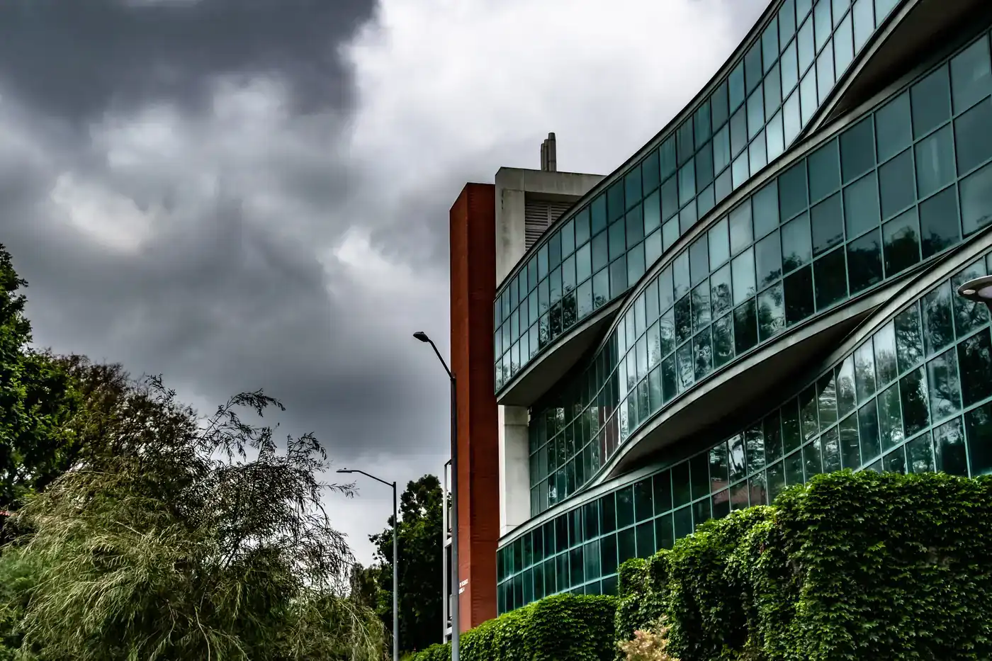 Storm clouds reflected in the glass of a science building at Cal Poly Pomona in Pomona, California