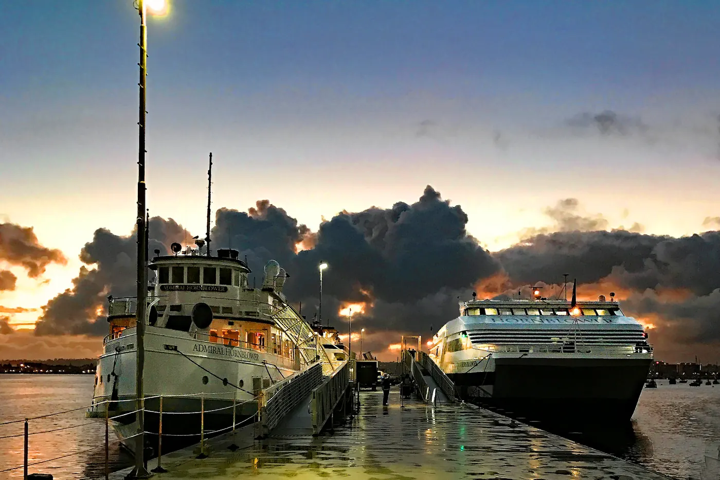 Breaking storm clouds over ships docked along San Diego Harbor