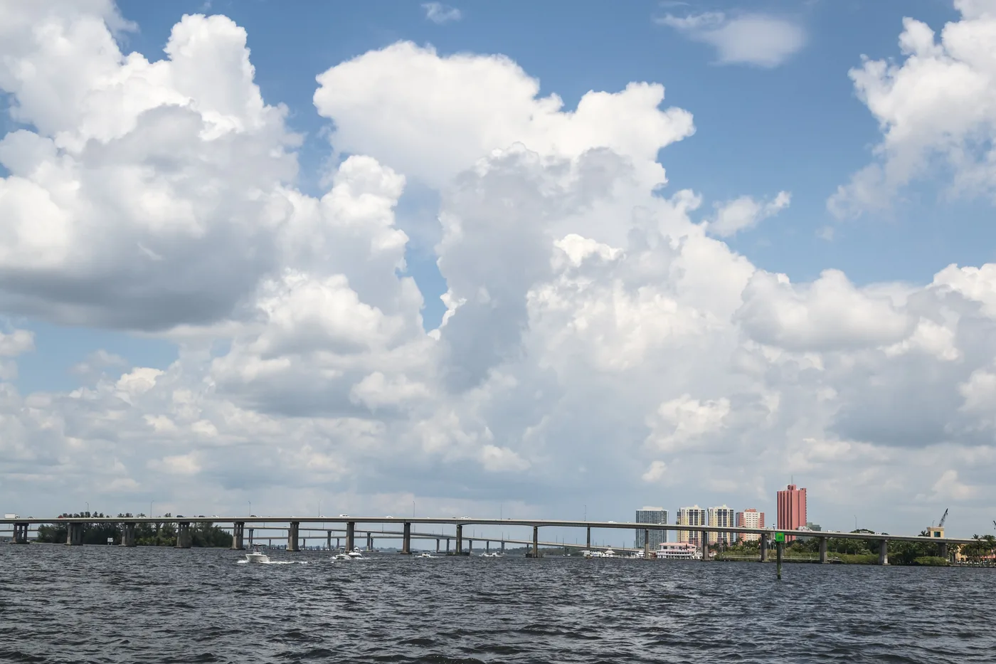 Towering clouds over the river and a long bridge at Cape Coral, Florida