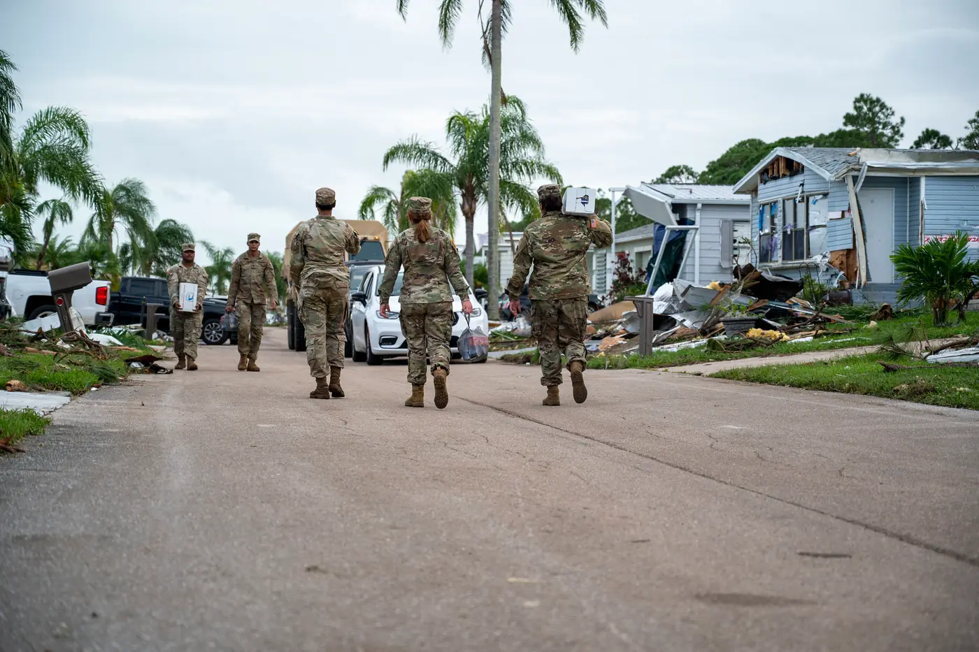 Florida National Guard soldiers walking a street of storm-damaged homes in Port St. Lucie's Spanish Lakes community in October 2024