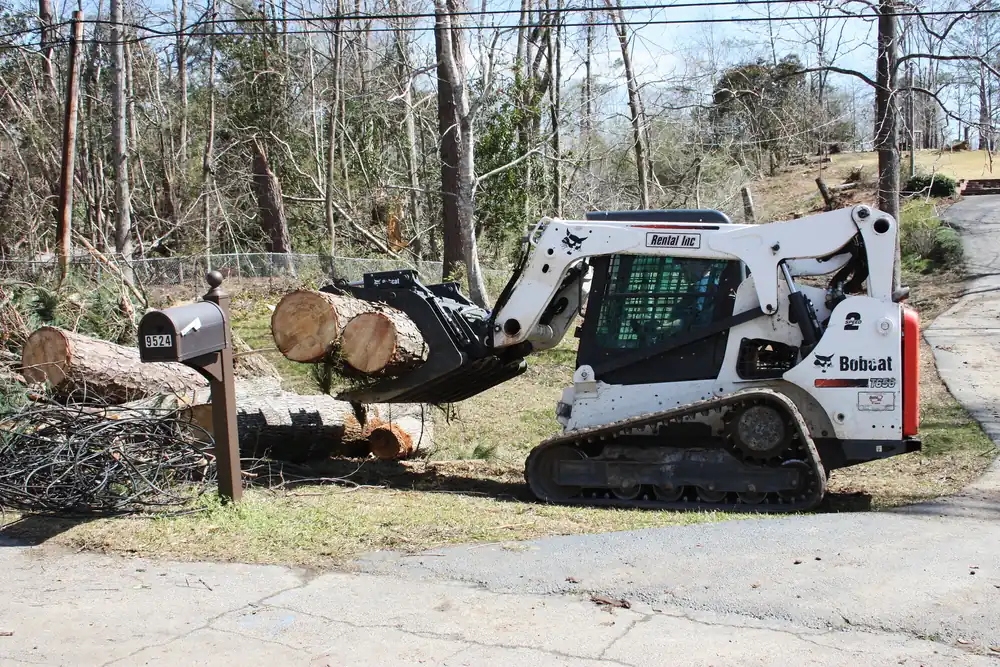 Skid-steer loader clearing trees downed by a March 2019 storm in Columbus, Georgia
