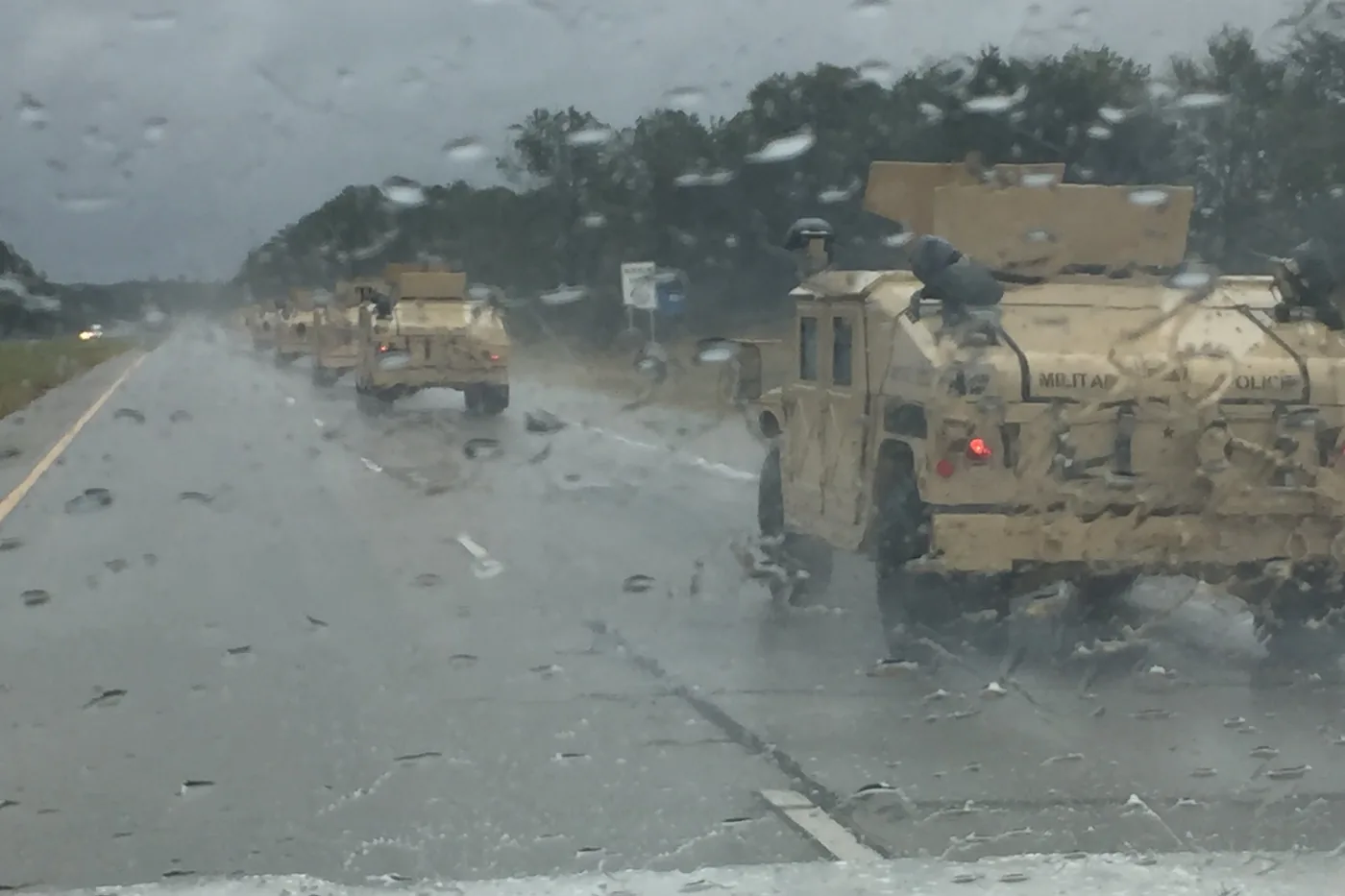Georgia National Guard trucks driving through wind and rain into Savannah during Hurricane Matthew in October 2016