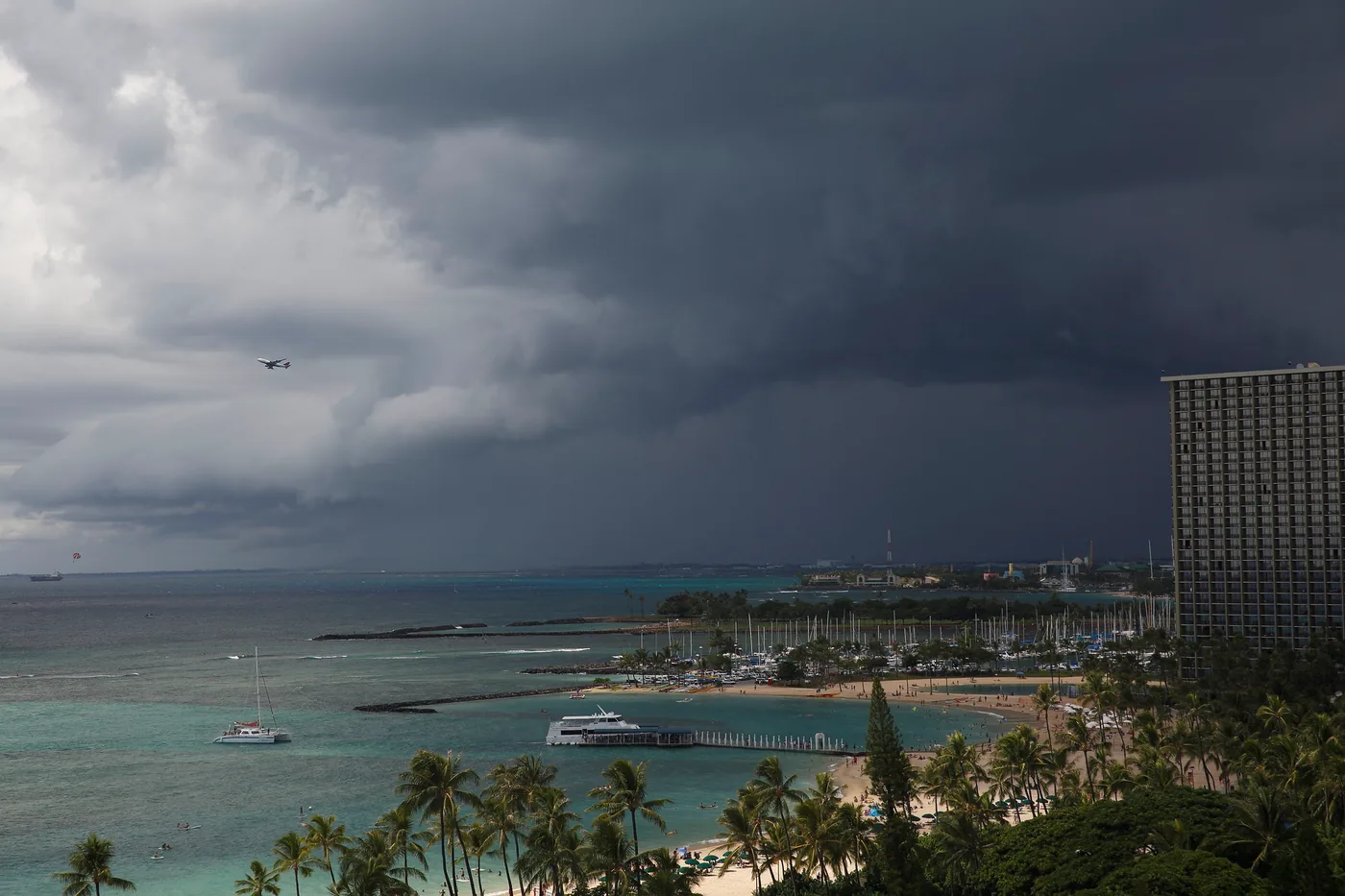 Storm clouds and a rain shower over the harbor and hotels of Waikiki, Honolulu
