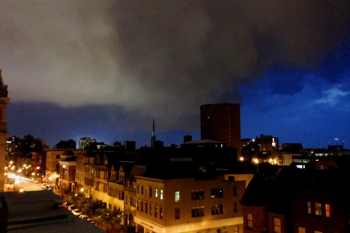Dark storm clouds over the rooftops of South Baltimore at night