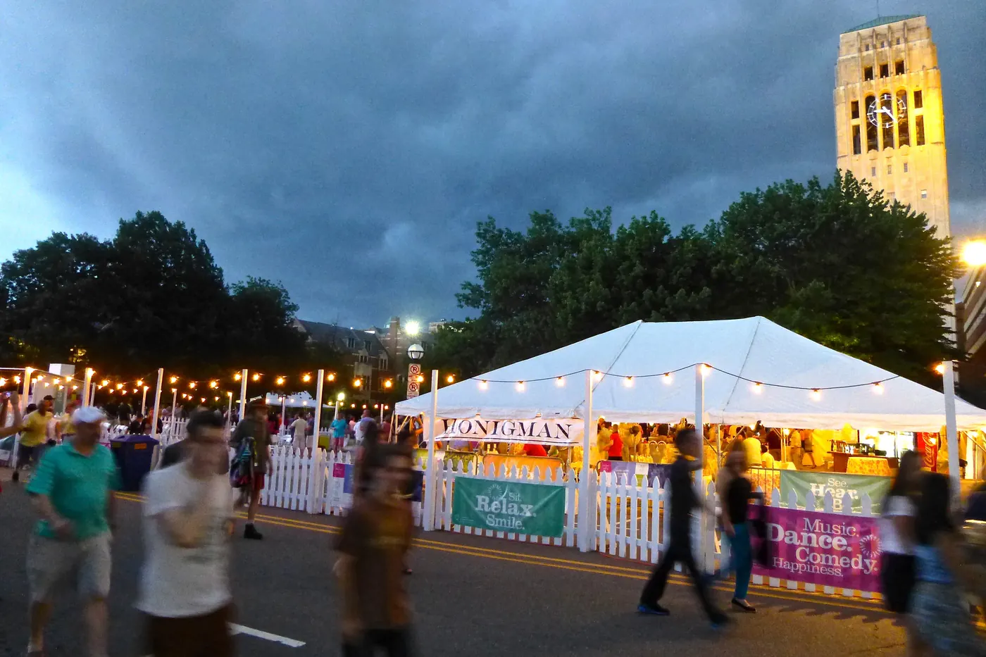 Ominous storm clouds over the Top of the Park festival crowd and Burton Tower in Ann Arbor, Michigan