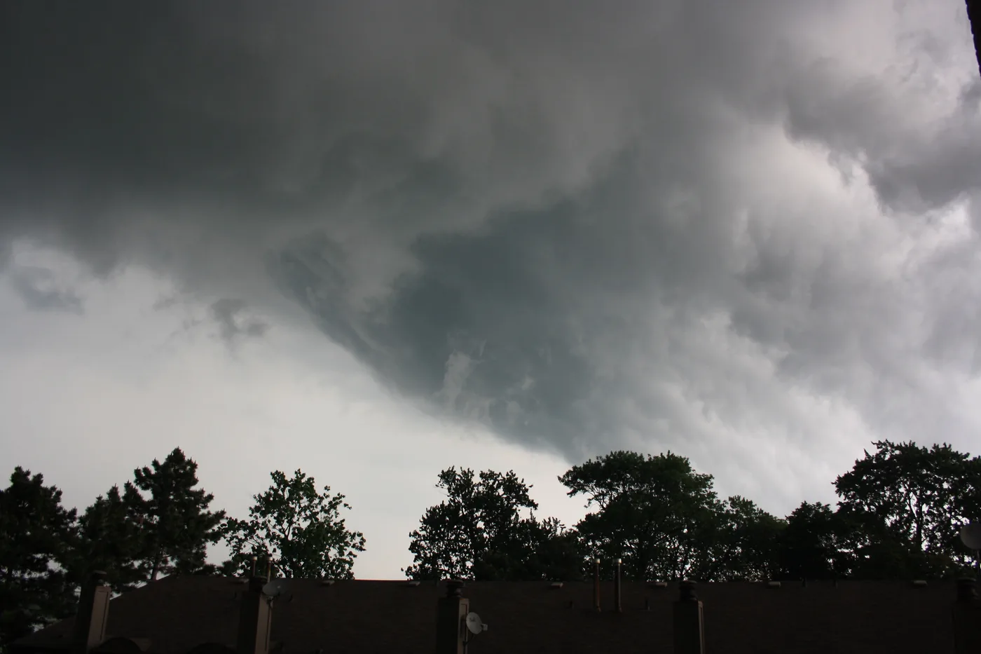 Thunderstorm clouds churning over the trees at the foot of George Avenue by the Detroit River