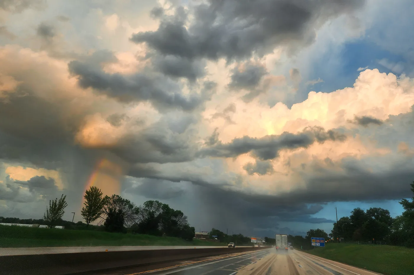 Thunderstorms with rain shafts building over an interstate highway on a tornado-warning day near St. Louis