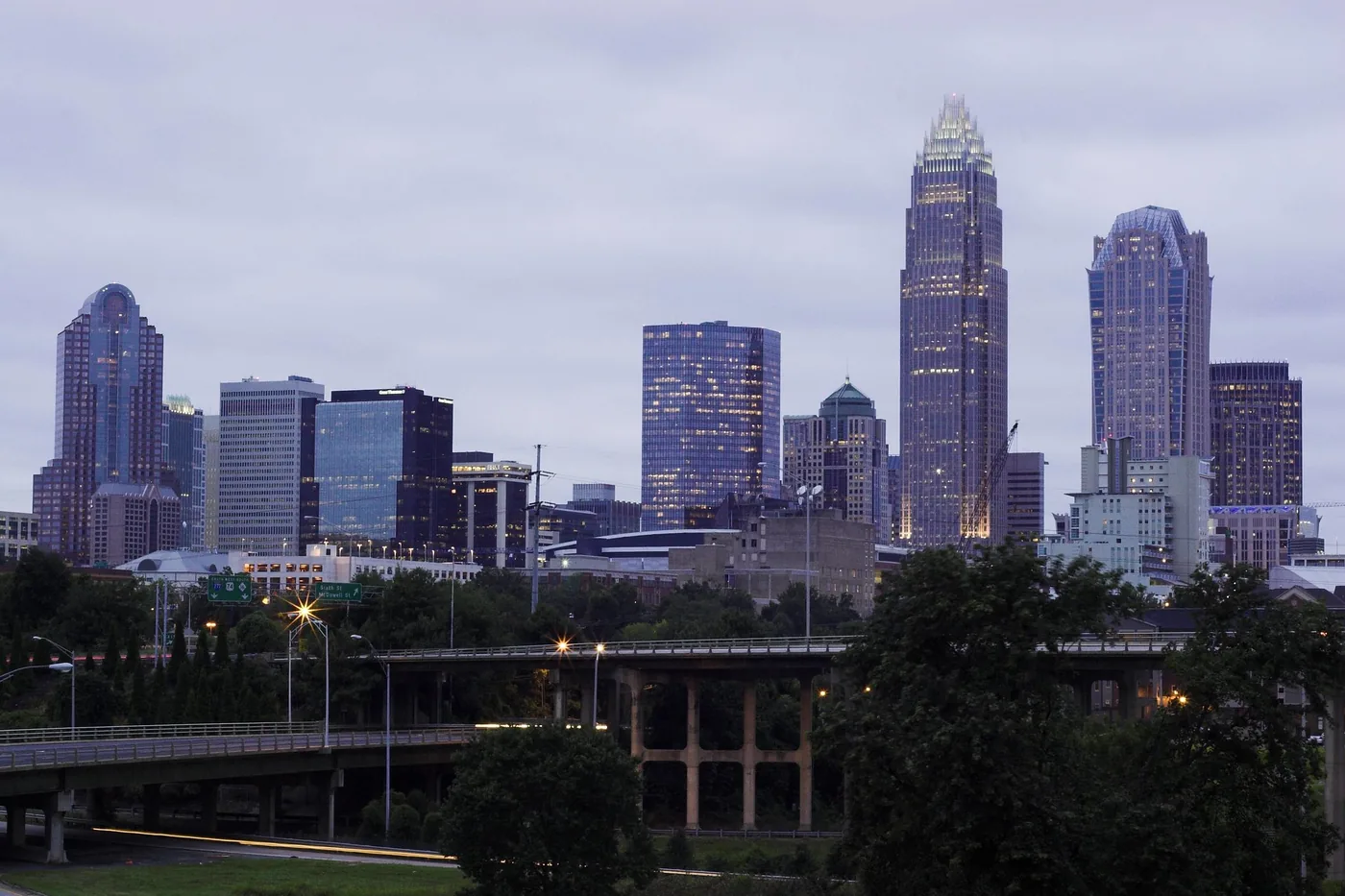 Uptown Charlotte skyline under stormy, overcast skies at dawn