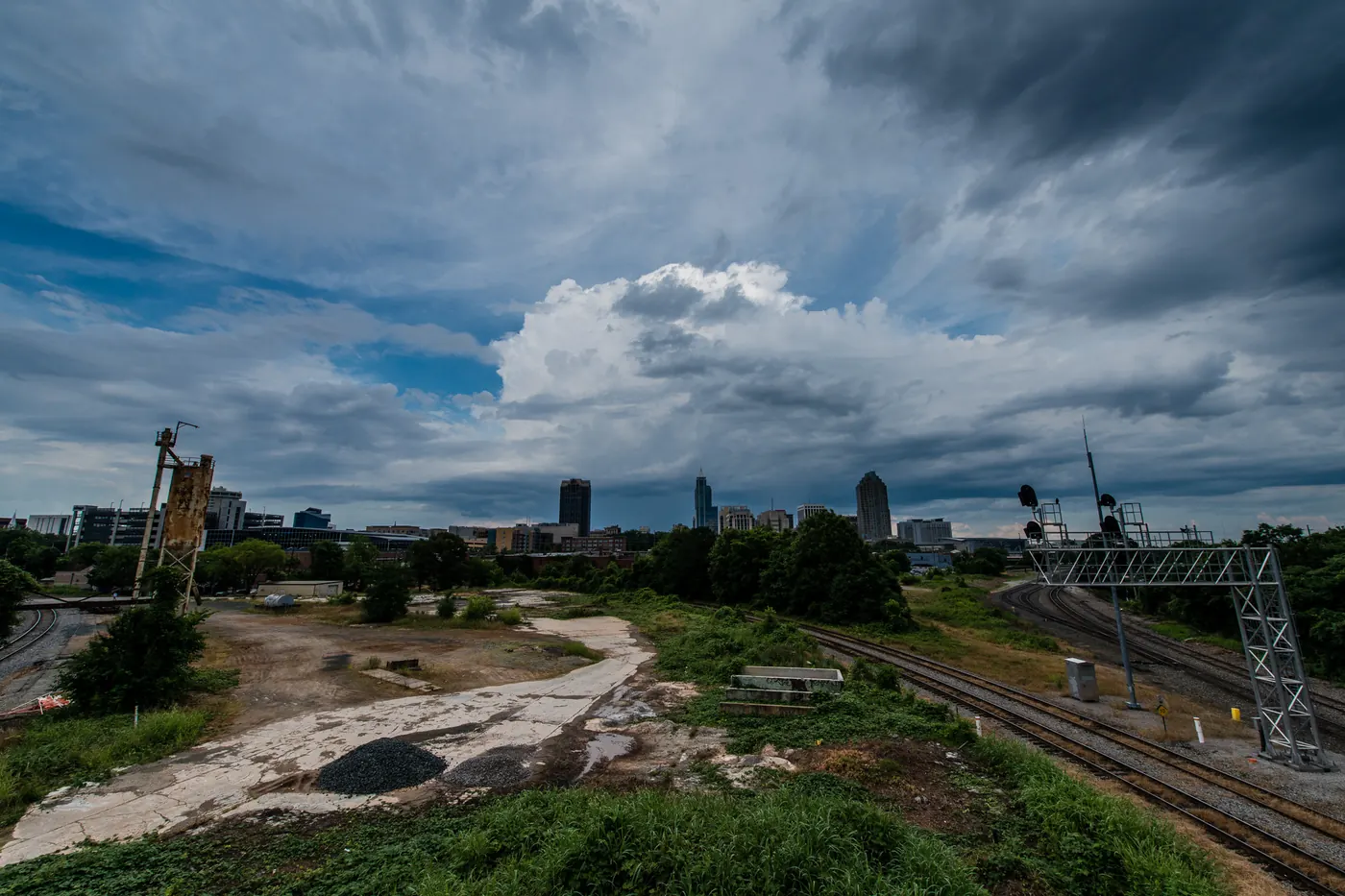 Thunderstorm clouds building over the downtown Raleigh skyline and rail yard, seen from the Boylan Avenue bridge