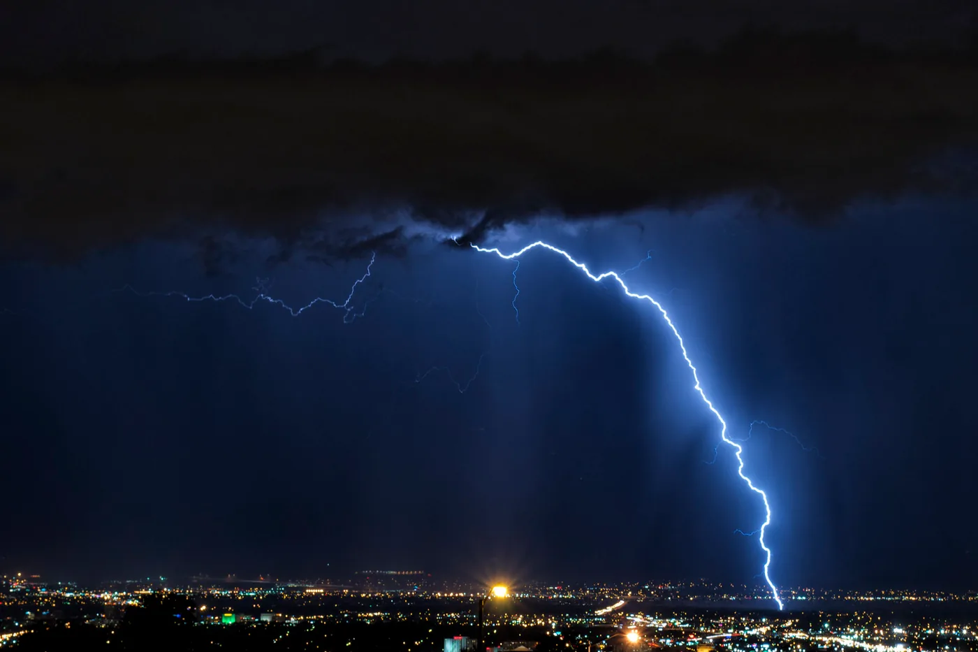 Cloud-to-ground lightning strike over the lights of Albuquerque, New Mexico, at night