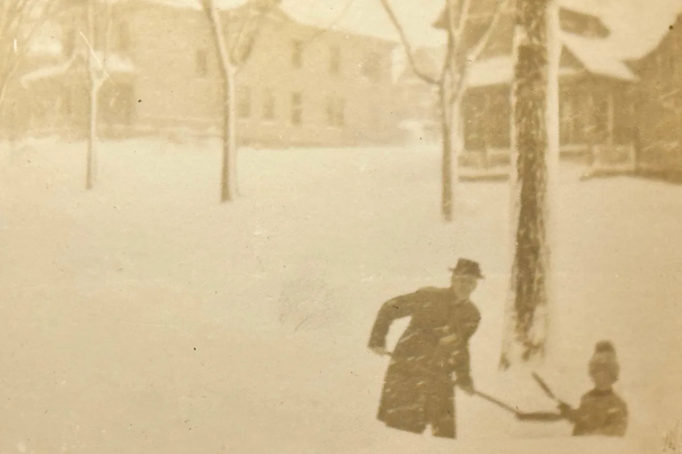Person shoveling snow in the midst of a snowstorm on Standart Street in Syracuse, New York, in an antique photo