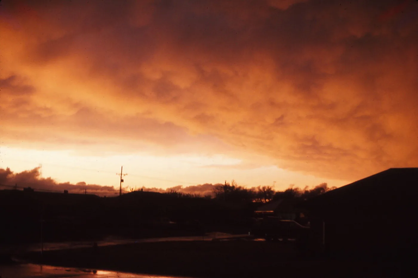 Orange storm sky at dusk over a Lawton, Oklahoma, neighborhood in April 1975