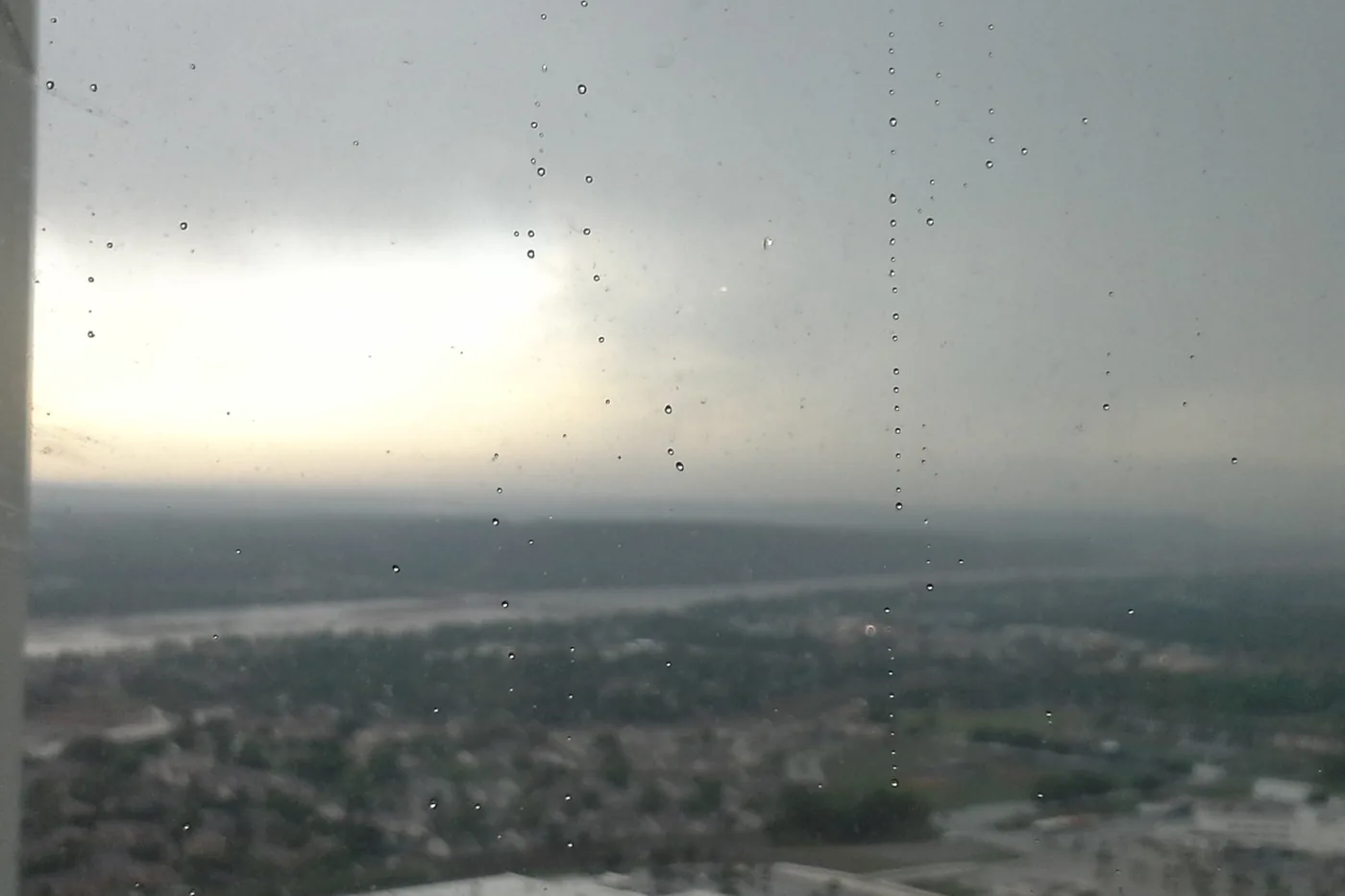 Thunderstorms arriving over Tulsa, Oklahoma, seen through a rain-streaked window looking north toward downtown