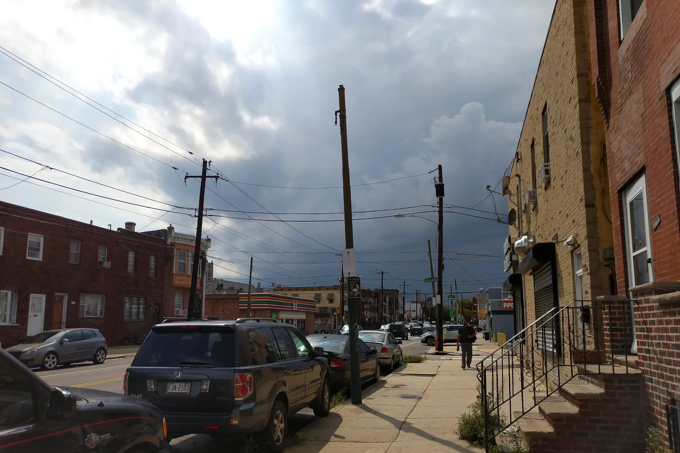 Stormy sky over row houses and parked cars on Snyder Avenue in South Philadelphia