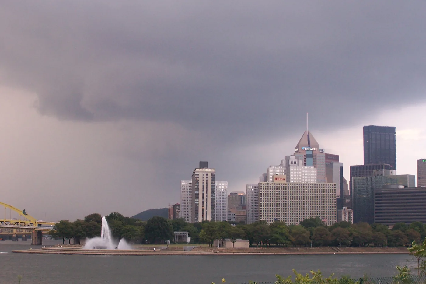Storm clouds gathering over the downtown Pittsburgh skyline and the Point State Park fountain
