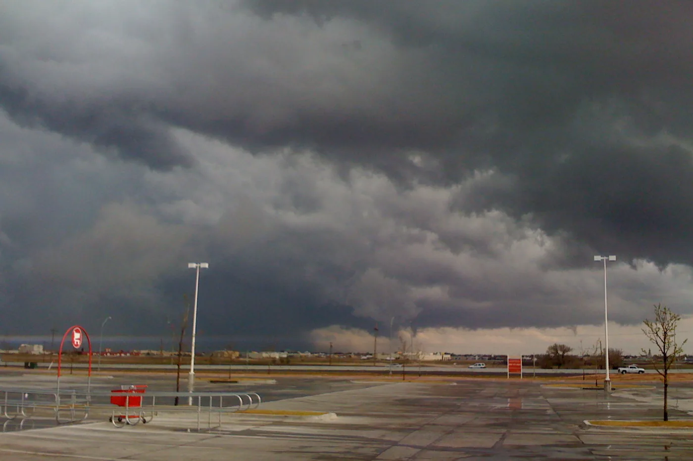 Dark storm clouds with a lowering over an open lot in Lubbock, Texas