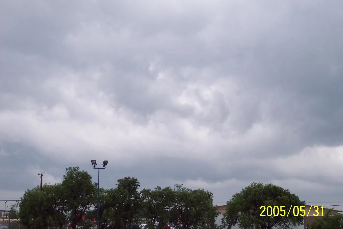 Gray storm clouds over trees in San Angelo, Texas, during a spell of tornado warnings