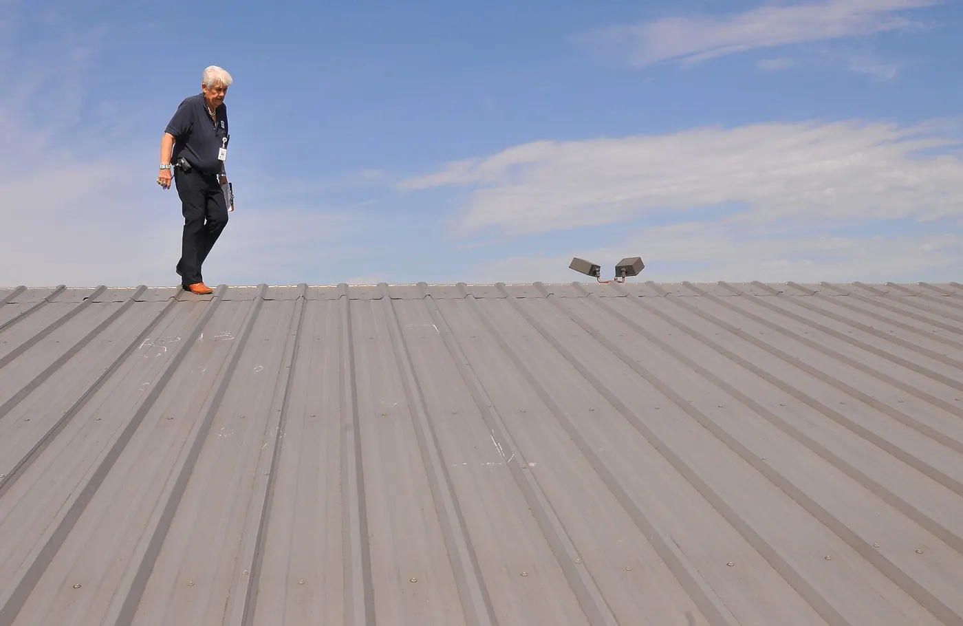 Inspectors documenting hail damage on a roof