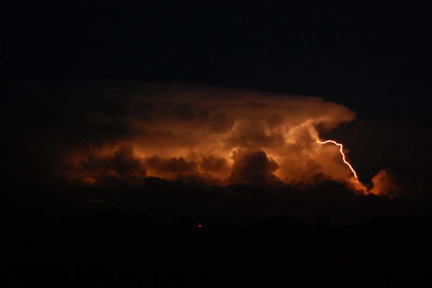 Lightning flashing inside a towering thunderstorm over Mount Magazine, Arkansas, at night