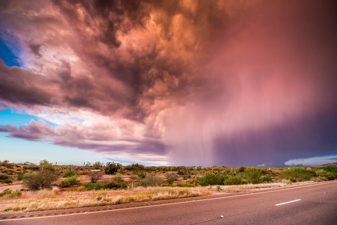 Monsoon thunderstorm with a rain shaft over desert scrub beside the Beeline Highway in Arizona
