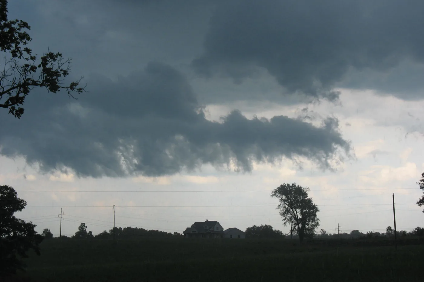 Dark storm clouds rolling over fields and trees near May's Lick, Kentucky