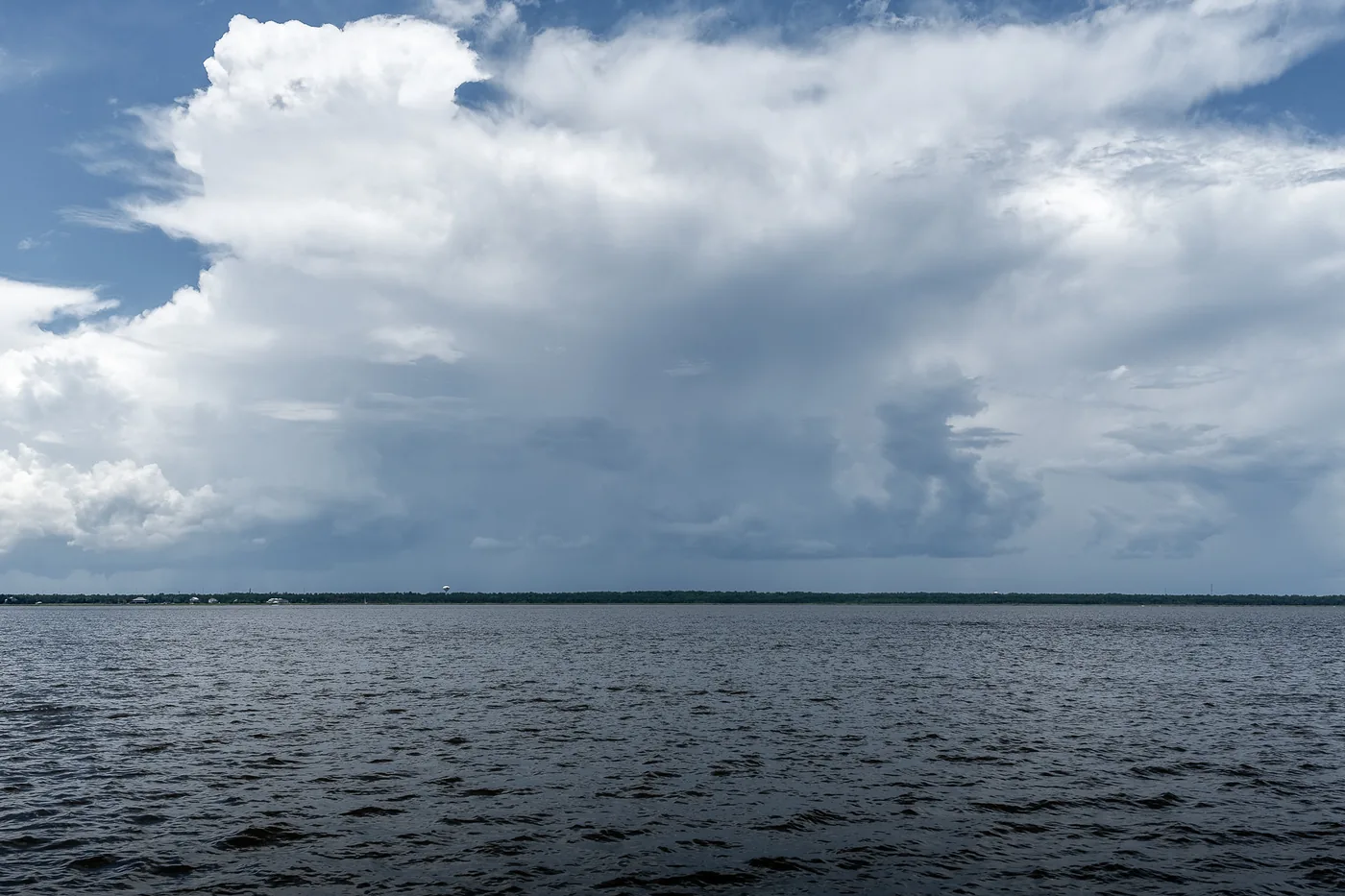 Thunderstorm clouds towering over open water in Mississippi
