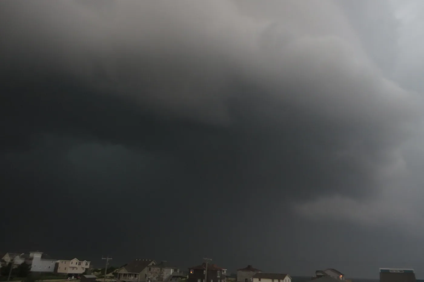 Dark, low thunderstorm clouds passing over beach houses in Nags Head on North Carolina's Outer Banks