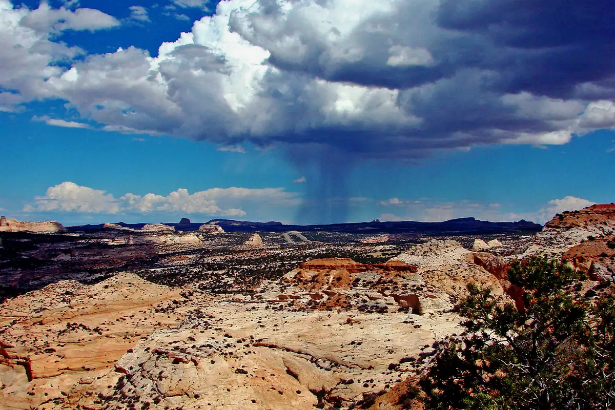 Rain shaft falling from a thunderstorm over the red-rock badlands of the San Rafael Swell, Utah