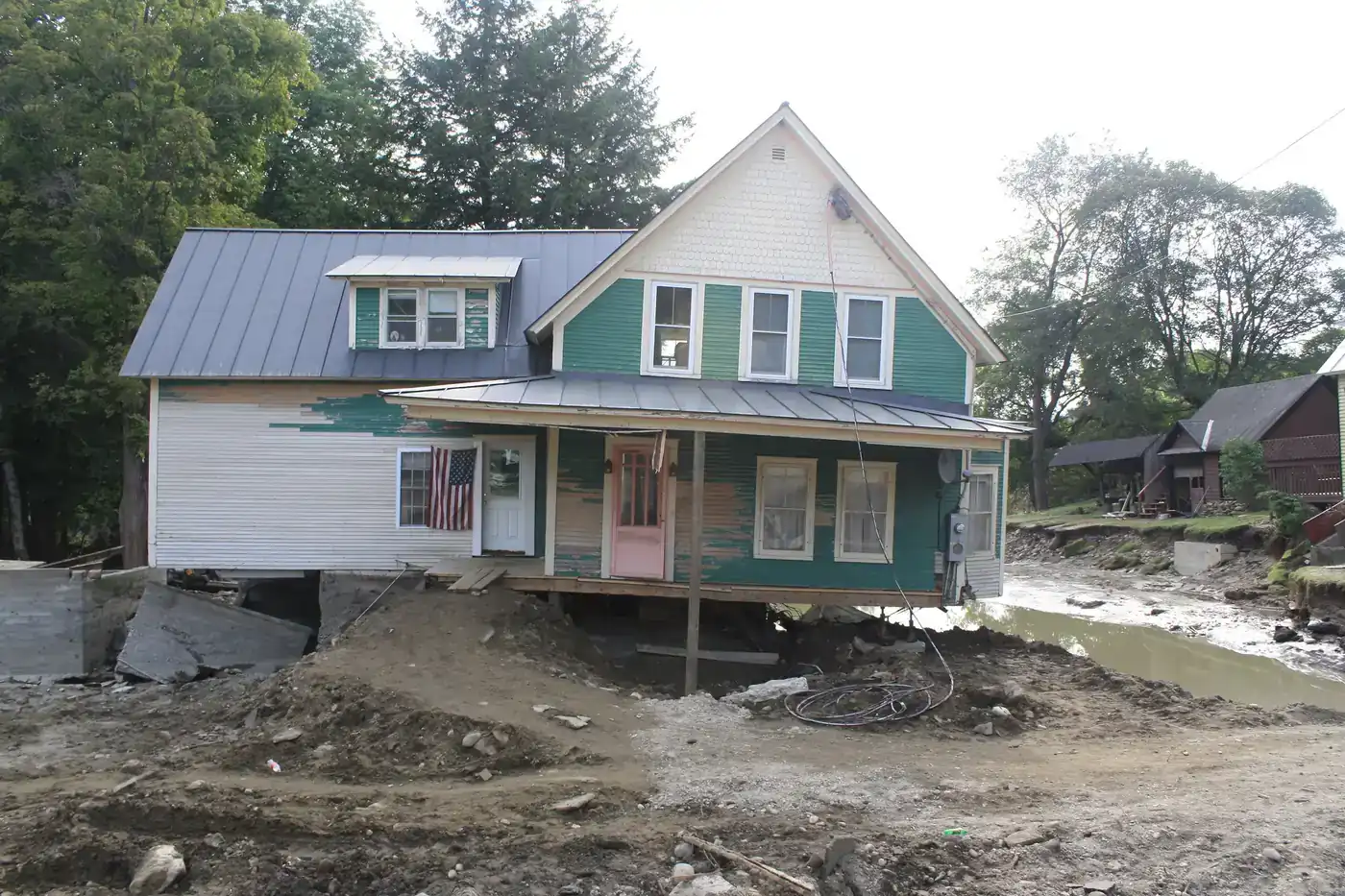 House pushed off its foundation beside a washed-out road after Hurricane Irene flooding in Bethel, Vermont
